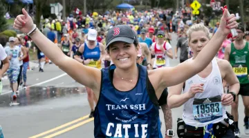 Catie Macaluso on running in the 2019 Boston Marathon with her arms raised.